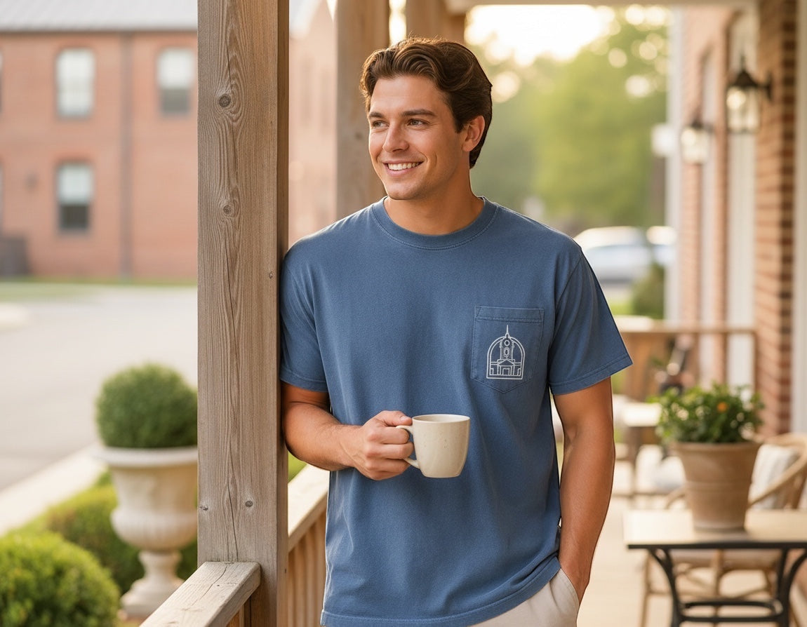Press Society blue cotton pocket t-shirt with Columbia, Tennessee skyline graphic on pocket. Model is wearing a size large.