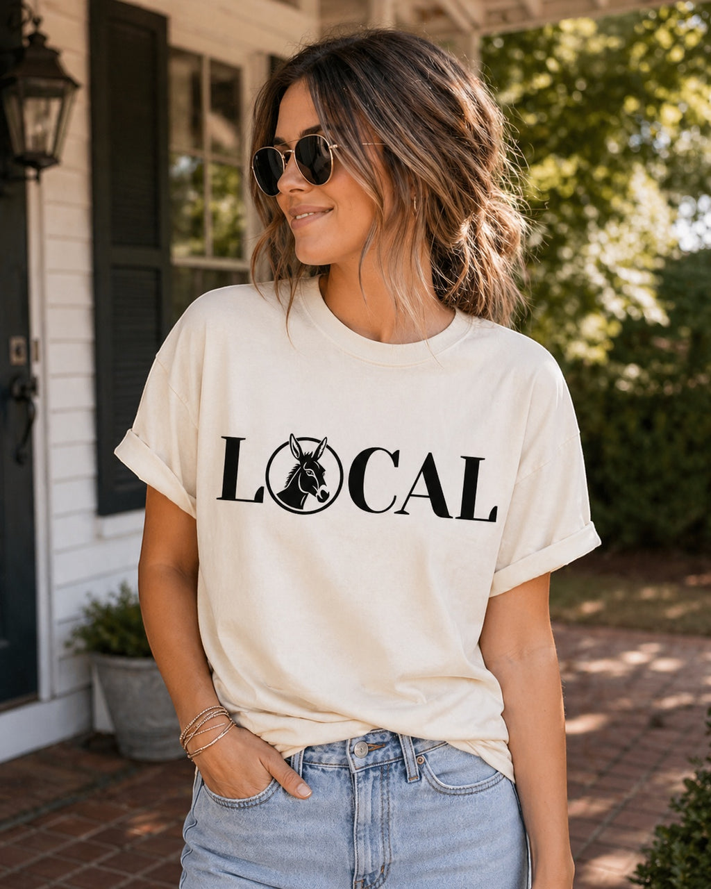 Press Society cream graphic t-shirt with black "LOCAL" text and donkey graphic. Relaxed fit, crew neck, short sleeves.