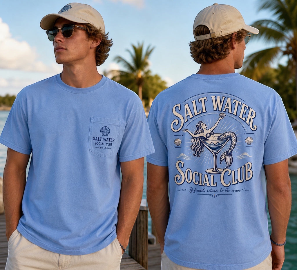 Press Society light blue cotton t-shirt with a mermaid graphic in a martini glass on the back and a seashell logo on the chest pocket.