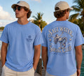 Press Society light blue cotton t-shirt with a mermaid graphic in a martini glass on the back and a seashell logo on the chest pocket.
