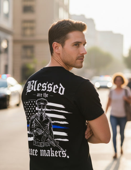 Press Society black graphic tee with a skeleton police officer holding a rifle, American flag, and the text "Blessed are the peace makers."