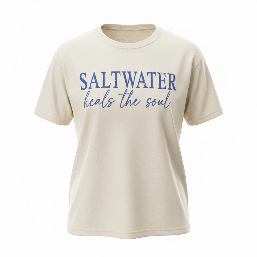 Press Society cream cotton t-shirt with blue distressed "Saltwater Heals the Soul" graphic print. Short sleeves, crew neck.