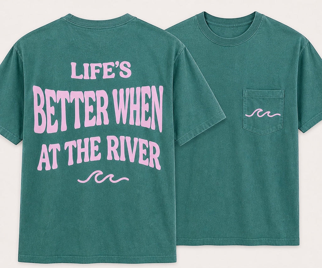 Press Society teal green cotton tee with pink 'Life's Better When At The River' graphic on back and wave detail on pocket.